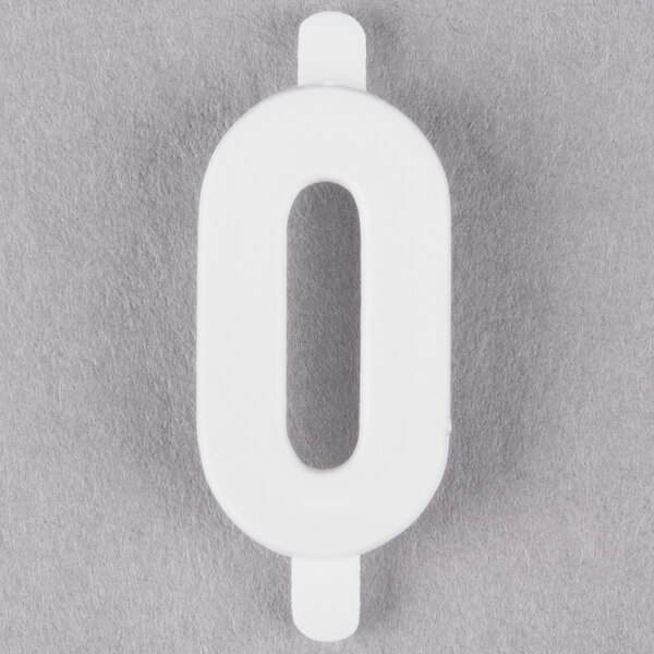 A white molded plastic number 0 insert with a cut out in the middle.