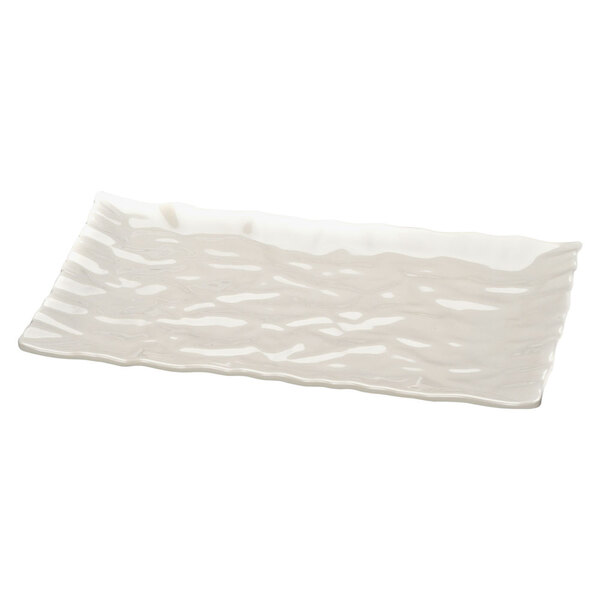 A white rectangular melamine tray with wavy edges.