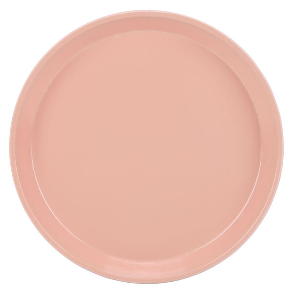 A pink Cambro round tray with a white background.
