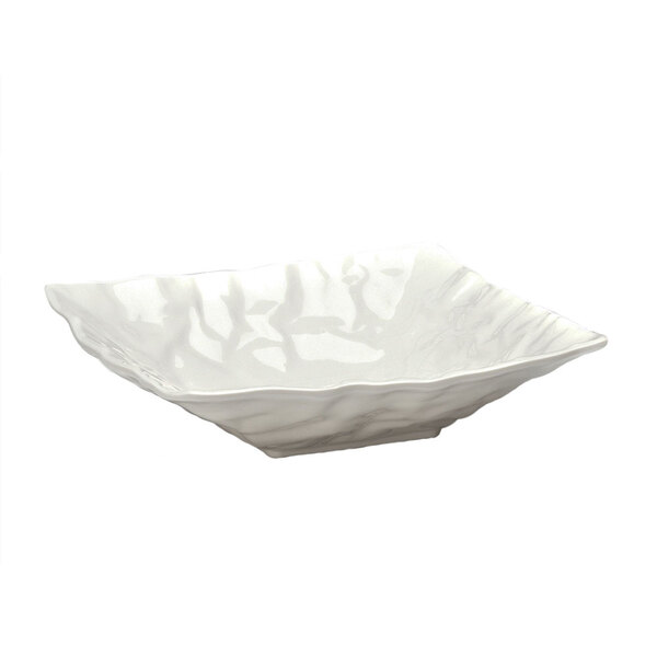 A white square melamine bowl with wavy edges.