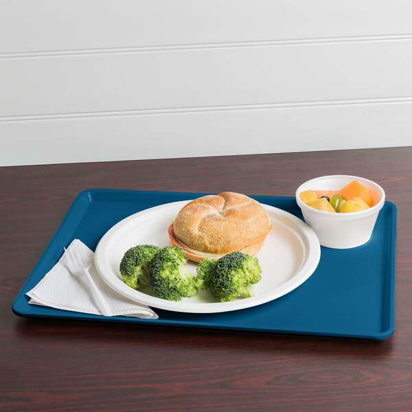 A Cambro dietary tray with a plate of food including broccoli.