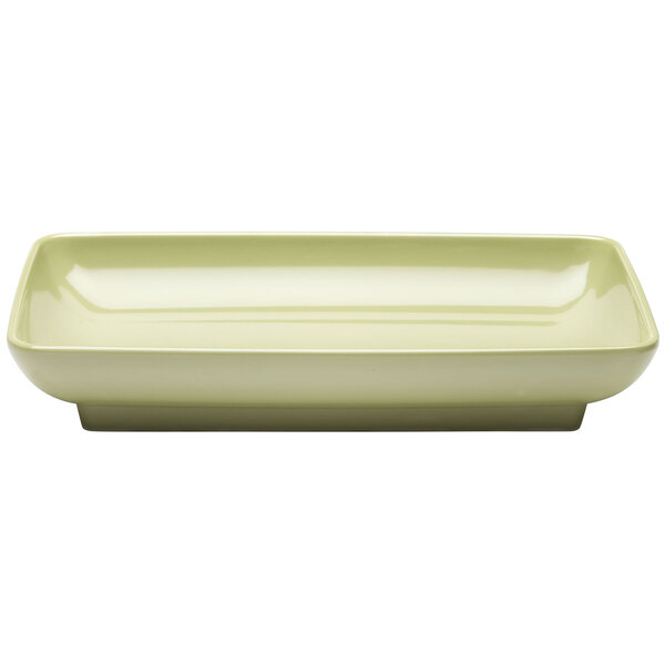 A rectangular white melamine platter with a green rim.