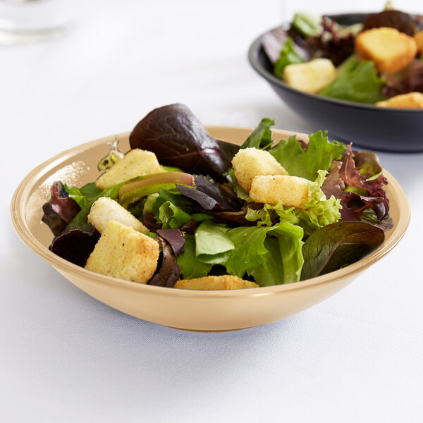 A close-up of a Cambro salad bowl filled with salad and croutons.