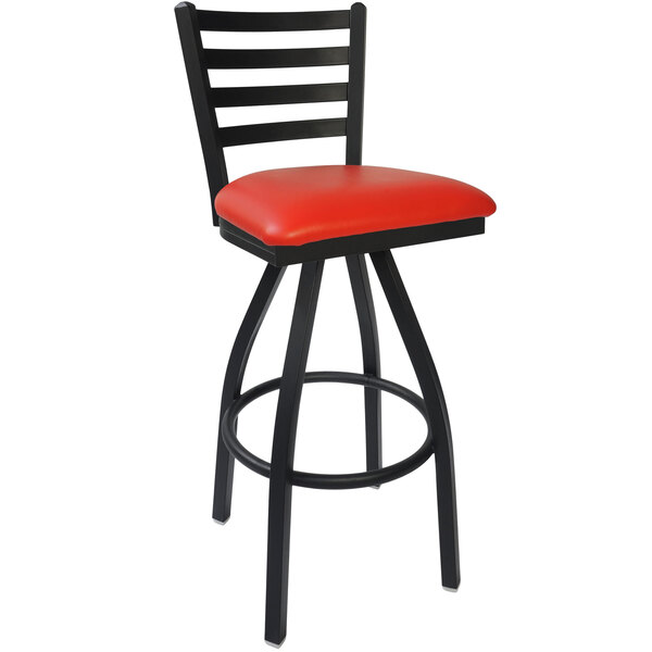 A BFM Seating black steel bar stool with a red vinyl swivel seat.