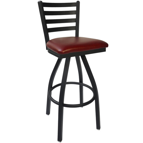 A BFM Seating black steel bar stool with a burgundy vinyl cushion.