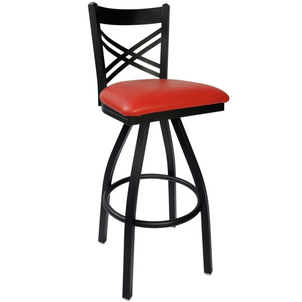 A black metal BFM Seating barstool with a red vinyl swivel seat.