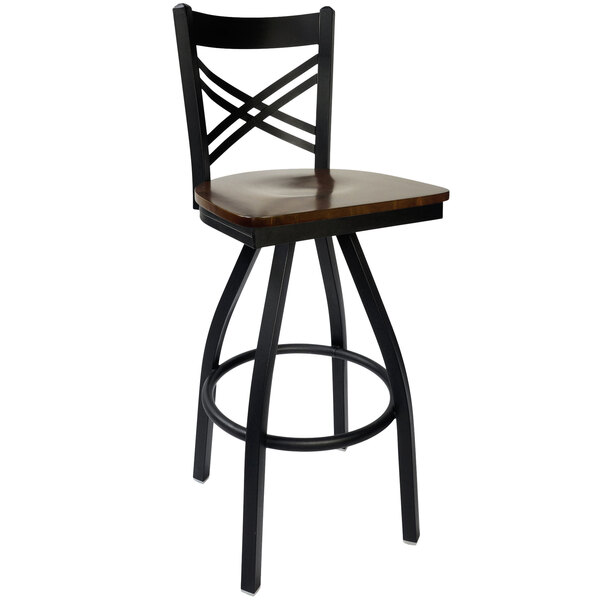 A black BFM Seating metal bar stool with a wood swivel seat.