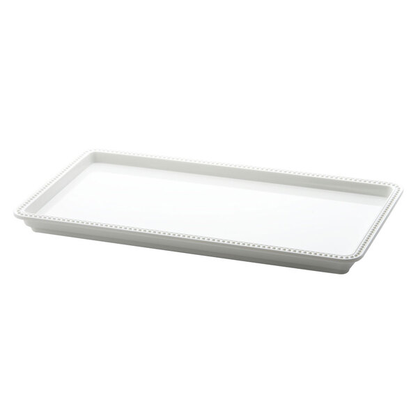 A white rectangular tray with a beaded edge.