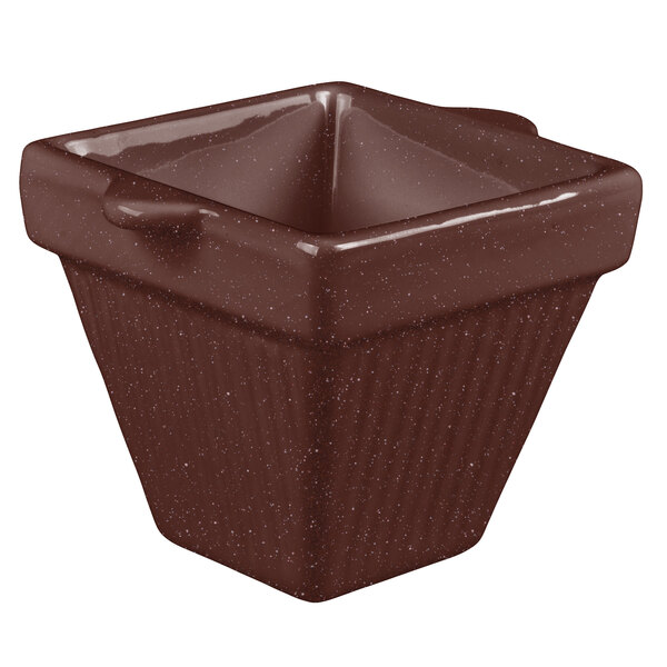 A brown square cast aluminum pot with a handle.