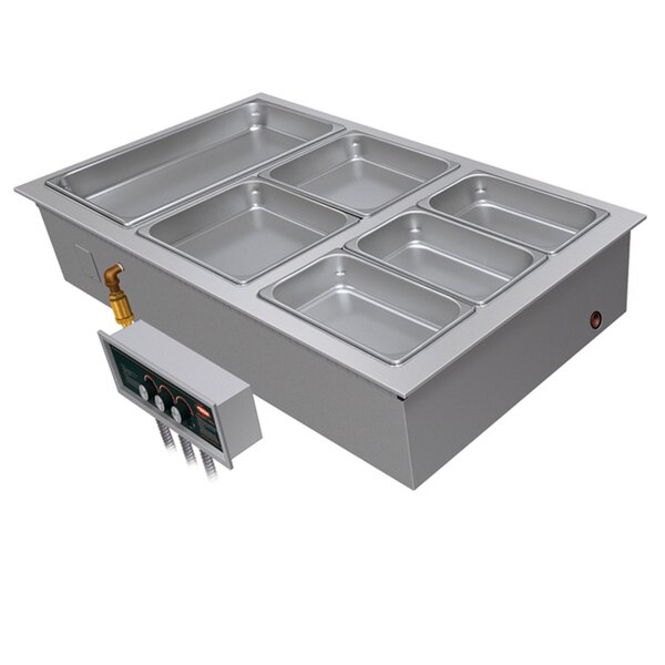 A Hatco drop-in hot food well with two compartments on a counter in a school kitchen.
