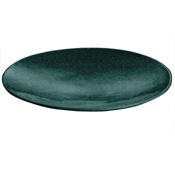 A hunter green metal flared platter with white speckles on a table.