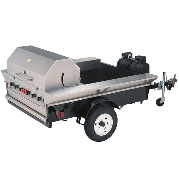 A silver Crown Verity Tailgate Grill on a trailer with black wheels.