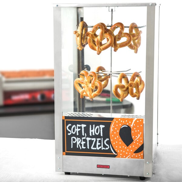 A Nemco countertop pretzel warmer displaying pretzels.