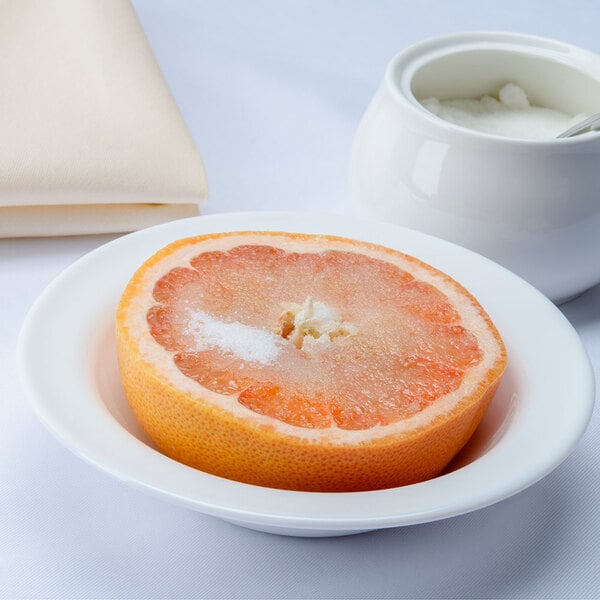 An Arcoroc white glass bowl filled with grapefruit