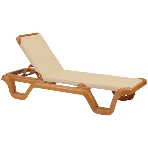 A tan and brown sling chaise lounge chair with a teakwood frame.