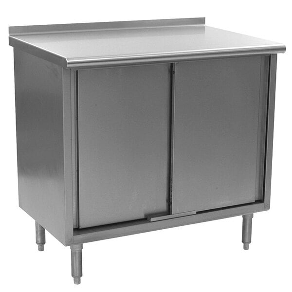 A stainless steel cabinet with two doors under an Eagle Group stainless steel work table.