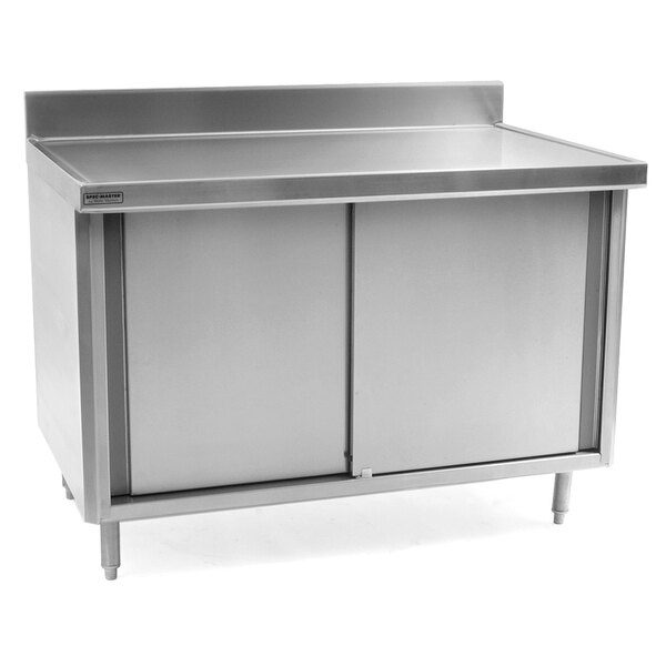 A stainless steel cabinet with a door under a stainless steel work table.