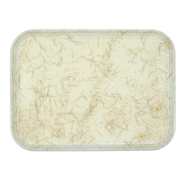 A white rectangular tray with brown sprinkles on it.