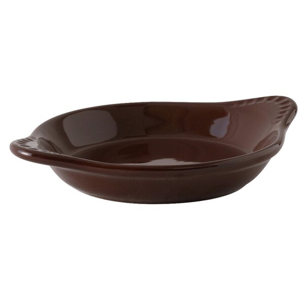 A mahogany brown Tuxton round shirred egg dish with a handle.
