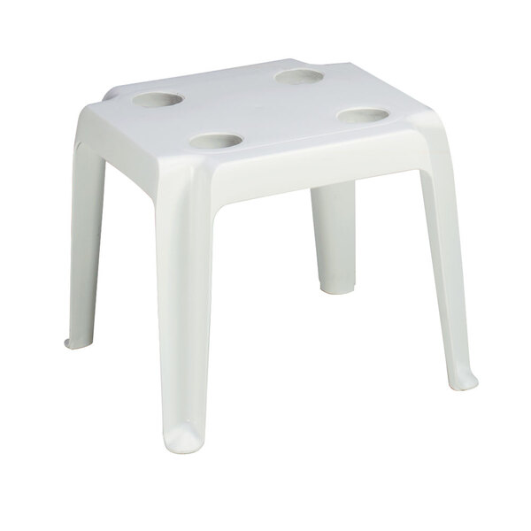 A white resin low table with cupholders.