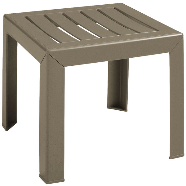 A taupe plastic Grosfillex low table with a slatted top on a patio.
