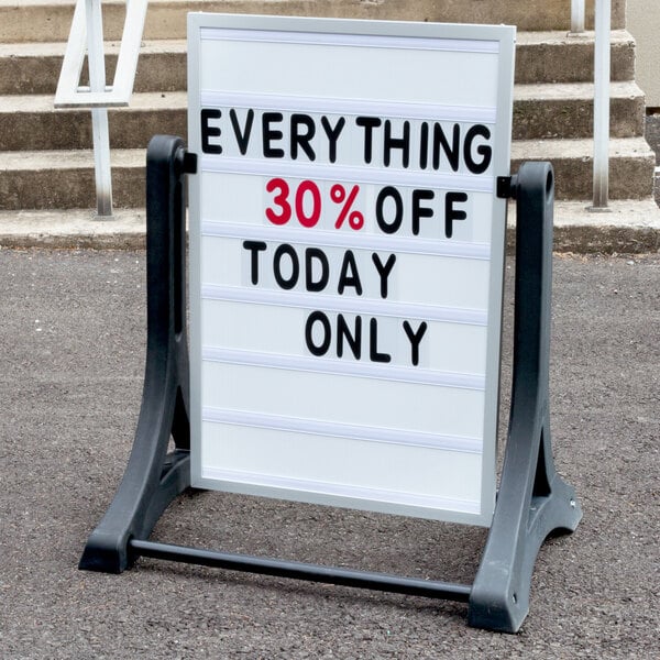 An Aarco white letterboard sign on a white metal A-frame stand.