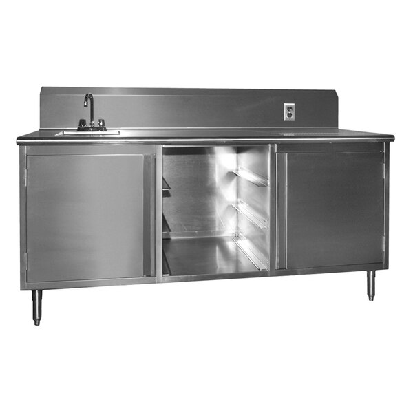 A stainless steel beverage table with a sink on the counter.