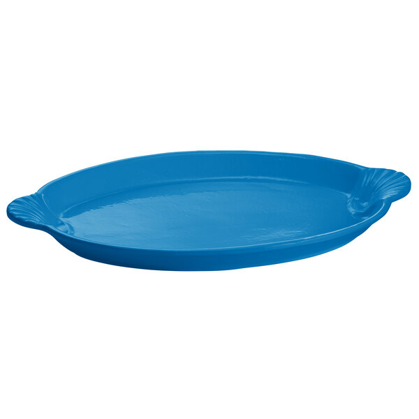 A sky blue cast aluminum oval shell platter with handles on a white background.