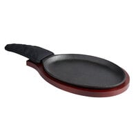 Choice 9 1/4" x 7" Oval Pre-Seasoned Cast Iron Fajita Skillet with Mahogany Finish Wood Underliner and Black Cotton Handle Cover