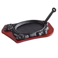 Thunder Group 14 1/3" x 8 1/4" Oval Cast Iron Fajita Skillet with Gripper and Wood Underliner