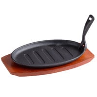 Thunder Group 12 5/8" x 7 1/8" Oval Cast Iron Fajita Skillet with Gripper and Wood Underliner