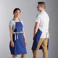 Choice Royal Blue Poly-Cotton Adjustable Bib Apron with 2 Pockets and Natural Webbing Accents - 32" x 30"