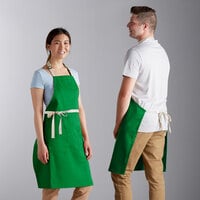 Choice Kelly Green Poly-Cotton Adjustable Bib Apron with 2 Pockets and Natural Webbing Accents - 32" x 30"