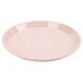 A light peach Cambro round tray with a white background.