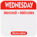 A white sticker with red text reading "Wednesday" and "Mercredi" in red and white.