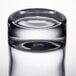 An Arcoroc clear shot glass with a white background.