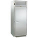 A large stainless steel Traulsen roll-thru refrigerator with open doors.