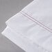 A white Oxford T200 Superblend flat sheet with red stitching.