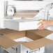 A woman in a white chef's uniform opening a Polar Tech Thermo Chill insulated shipping box.