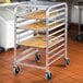 A Cres Cor unassembled metal sheet pan rack with trays of cookies on it.