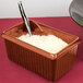 A Tablecraft brown rectangular server with white rice and a spoon.