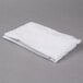 A folded white Oxford T300 Super Deluxe fitted sheet on a gray surface.