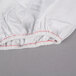 A white fabric with red stitching.