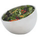 A Vollrath metal serving bowl filled with salad and vegetables.