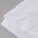 A close up of a white Oxford T300 Super Deluxe flat sheet.