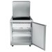A stainless steel Traulsen refrigerated sandwich prep table with a door open.