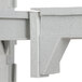 A close-up of a white plastic Cambro Camshelving connector corner.