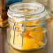 A Libbey Garden Jar filled with lemons on a counter.