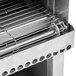 A stainless steel grill with a wire rack on an APW Wyott conveyor toaster.