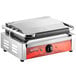 An Avantco commercial panini grill with stainless steel plates and a red handle.